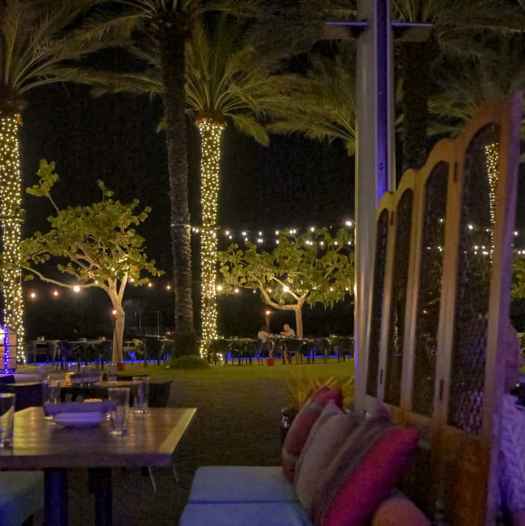 Beautiful view of the Camana Bay Crescent with lights over the water from a table at Pani