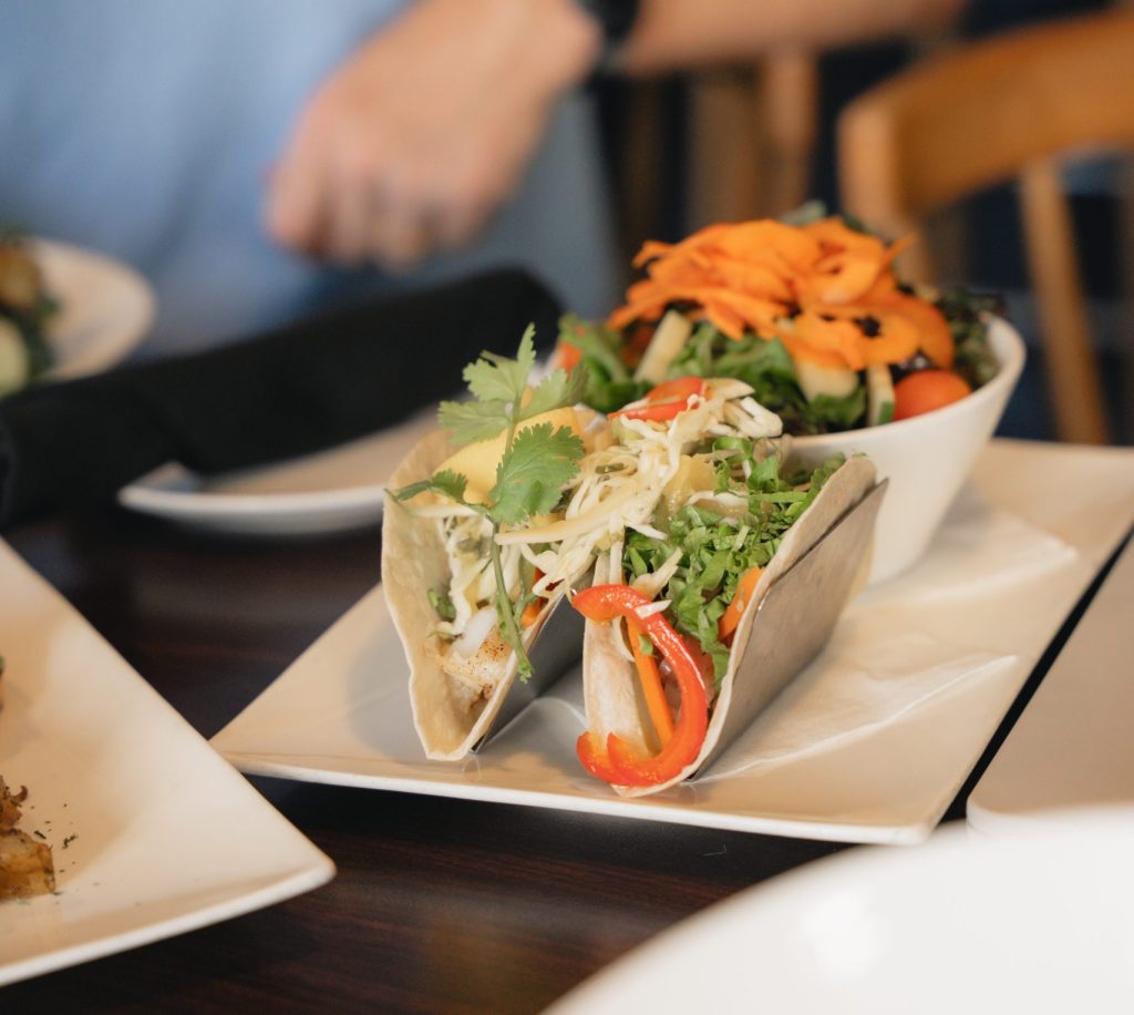 Picture of fresh tacos on a table at a restaurant displaying an affordable meal in Cayman