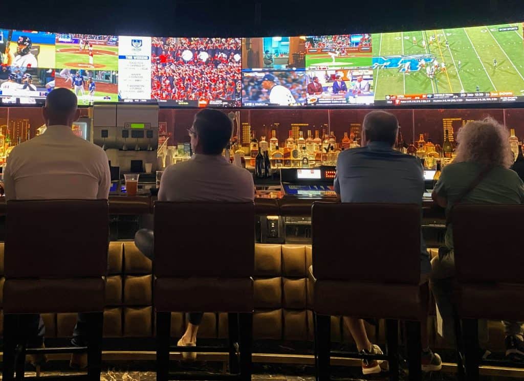 People watching sports on tvs at a sports bar